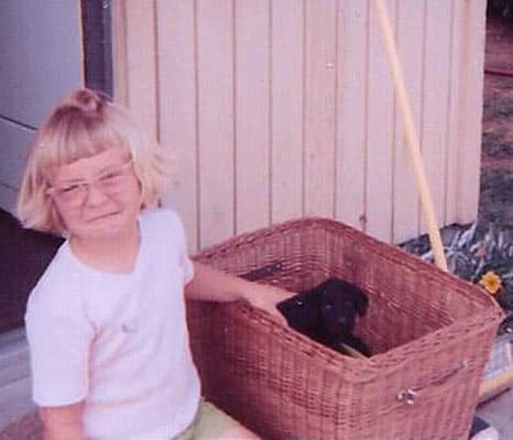 Girl with dog in basket